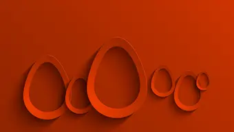 Abstrakcyjna grafika przedstawiająca trójwymiarowe wycinanki obrysów jajek o różnych rozmiarcach. Całość utrzymana w czerwonej tonacji.